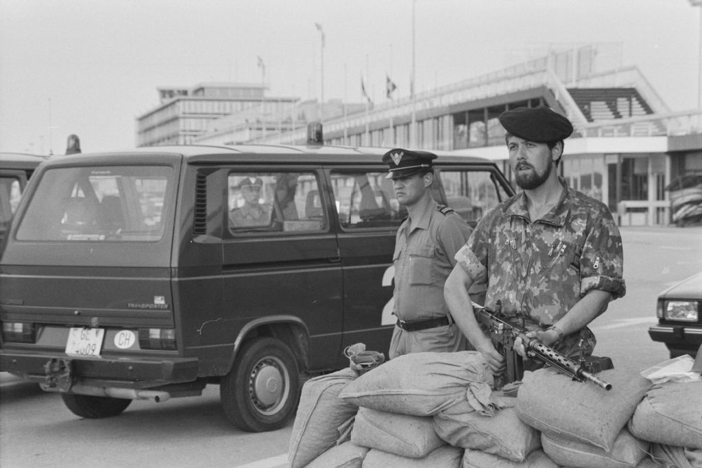 Geneva, Cointrin, sentry with assault rifle 57 behind sandbags