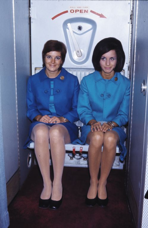 Two hostesses on the jumpseat in the back door of a Douglas DC-9 of Swissair