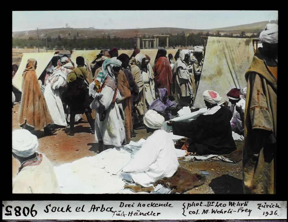 Souk el Arba, three squatting cloth merchants