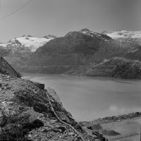Mattmark, dam construction, view to south-southwest (SSW) over the eastern end of the dam to Monte Moro and Rothorn.