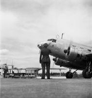 Swissair station agent in front of a Douglas DC-2 in Dübendorf