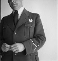 Check-in clerk in chief position [?] with Swissair badge on chest