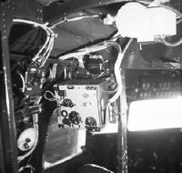 Electrical and radio equipment between cockpit and cabin, usually behind the insulation mat