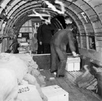 Mail loading into the cargo hold of the Douglas C-47 B-5-DK Douglas DC-3 Freighter, HB-IRD in Basel-Mulhouse