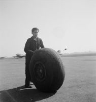 Swissair mechanic with airplane wheel