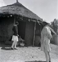 Abyssinian in front of hut