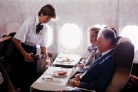 Meal and beverage service in the first class cabin of a McDonnell Douglas DC-10 of Swissair