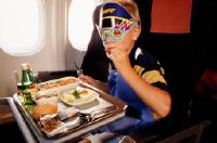 Boy with the children's menu in the economy class cabin of a Swissair McDonnell Douglas MD-11