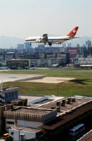 Boeing 747-357, HB-IGD "Basel Stadt" landing over the runway entrance from "Kai Tak" Airport in Hong Kong