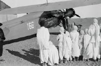 Group of children in front of Fokker F.VII b-3m, CH-166 (HB-LAO)