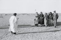 Group in front of car in desert