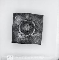Photographs of various iron plates bombarded with shaped charges