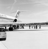 Passenger boarding through the rear economy class entrance of a Swissair Douglas DC-9-15 at Geneva-Cointrin