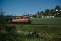 Between Räterschen and Schottikon, next to the Eulach, railroad line, SBB Re 4/4 II in Swiss-Express colors with train